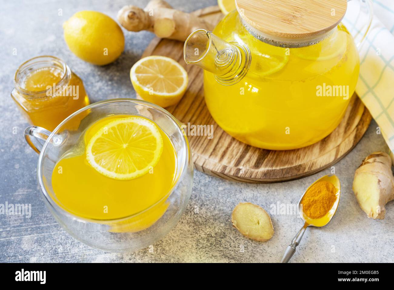 Antioxidant ginger turmeric lemon tea with honey on a stone table ...