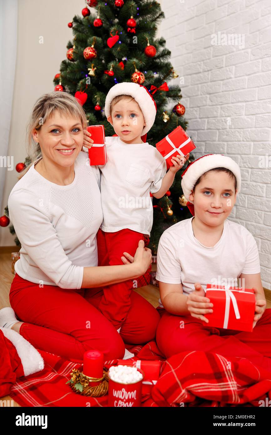 Happy parent and kids playing with christmas tree decorations Stock Photo