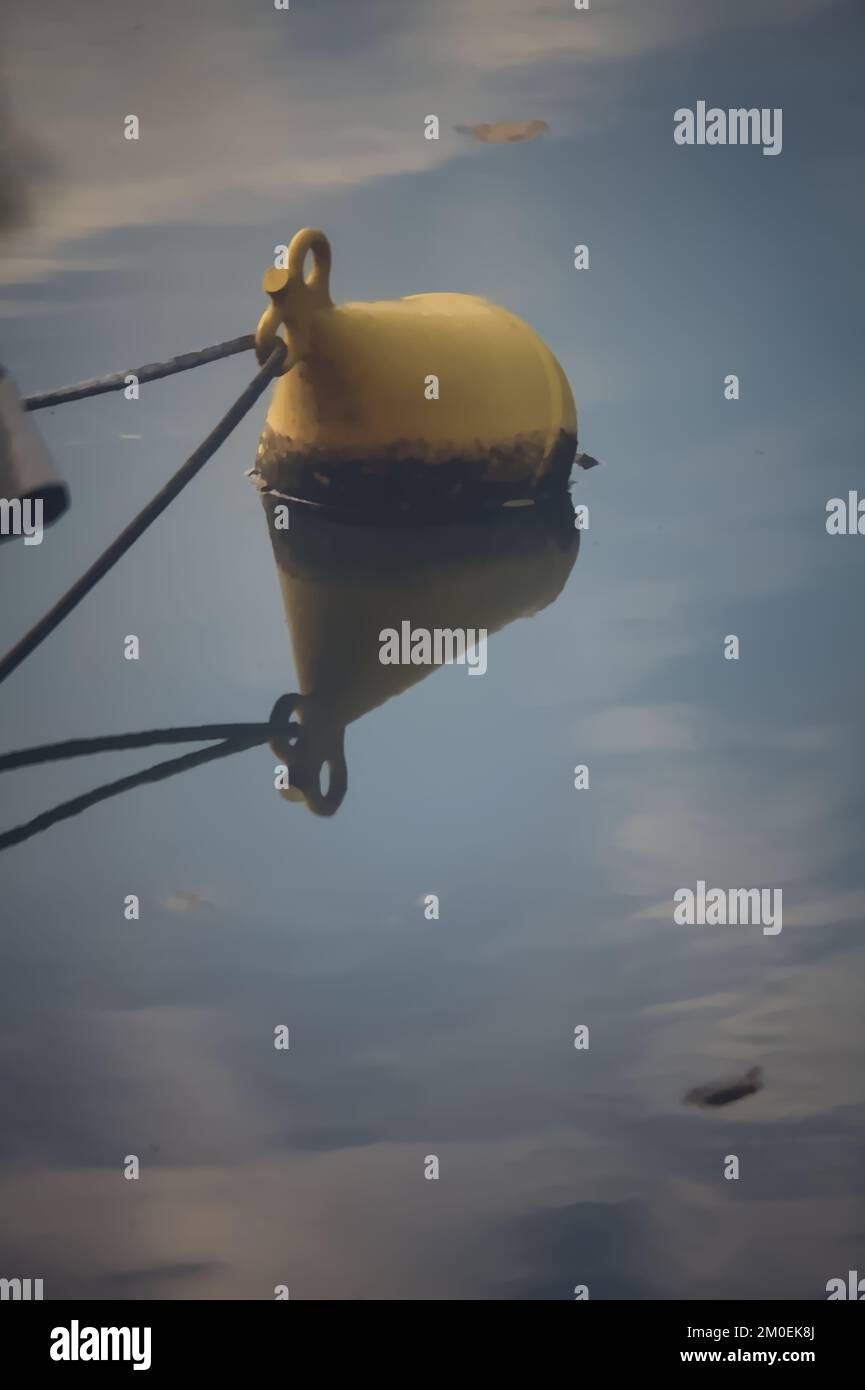 Buoy tied on a rope floating on water and casting its reflection Stock ...