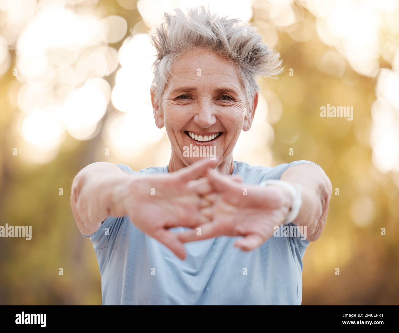 Portrait, senior woman and stretching hands, outdoor and exercise for ...