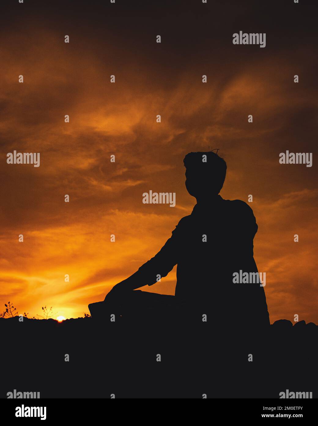 Male meditating silhouette hi-res stock photography and images - Alamy