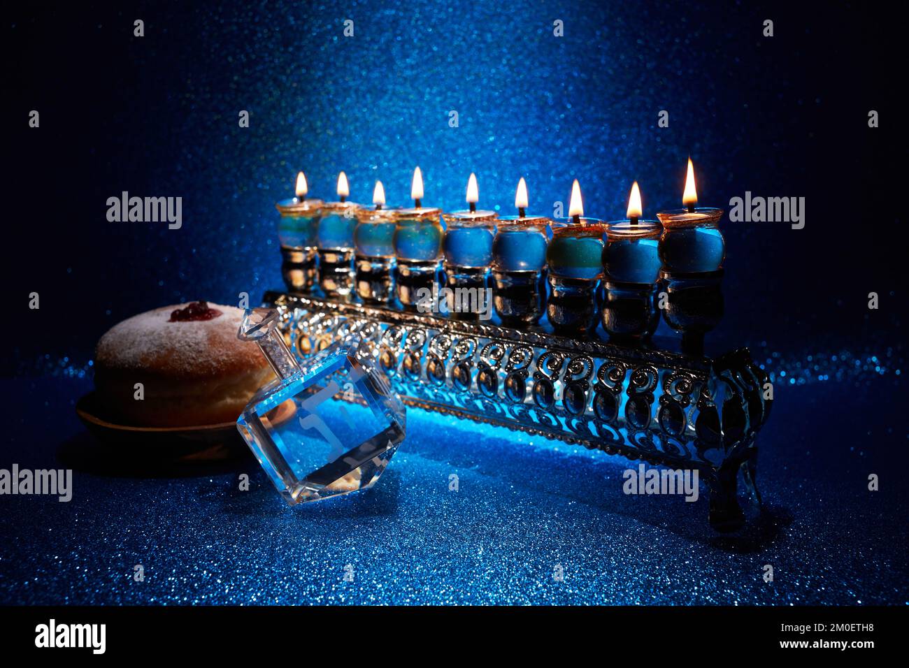 Jewish holiday Hanukkah background with menorah and dreidel with