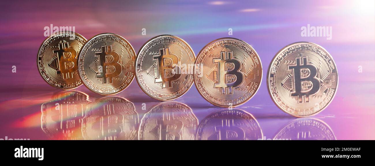Golden bitcoin coins on holographic, abstract, neon background. digital currency, business style. Mining and trade bitcoin concept. banner Stock Photo