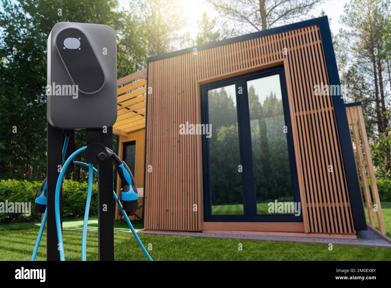 Wooden country house in the forest with an electric car charging station Stock Photo