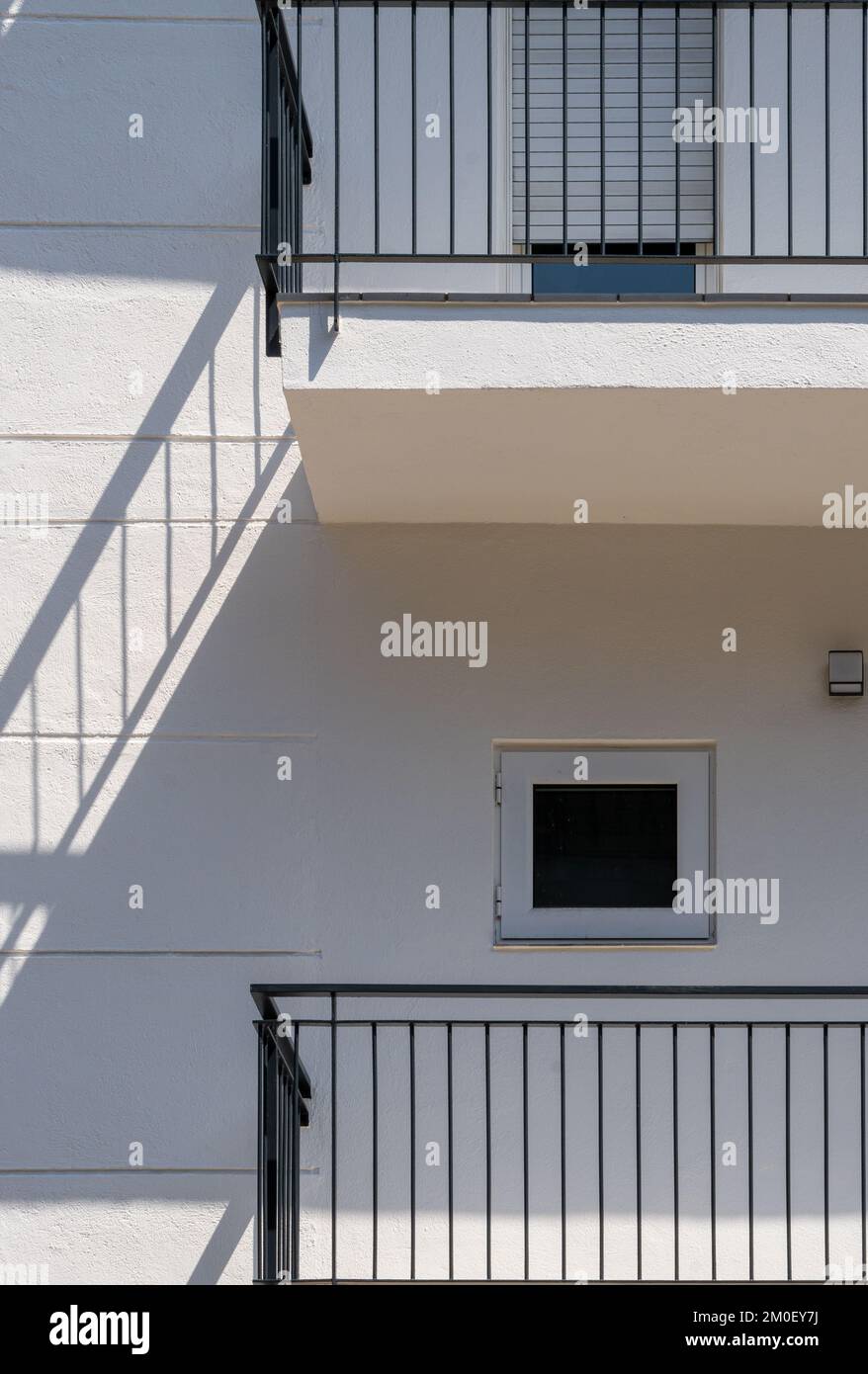 White facade of a flat building with minimalist design and small ...