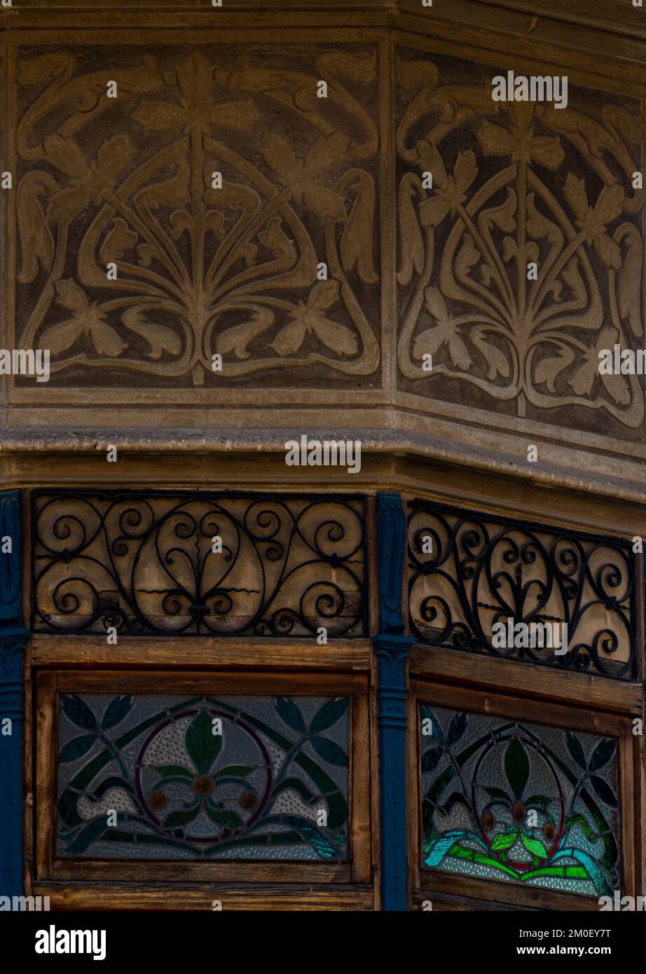 Ornate details of balcony and modernist window of old palace house in