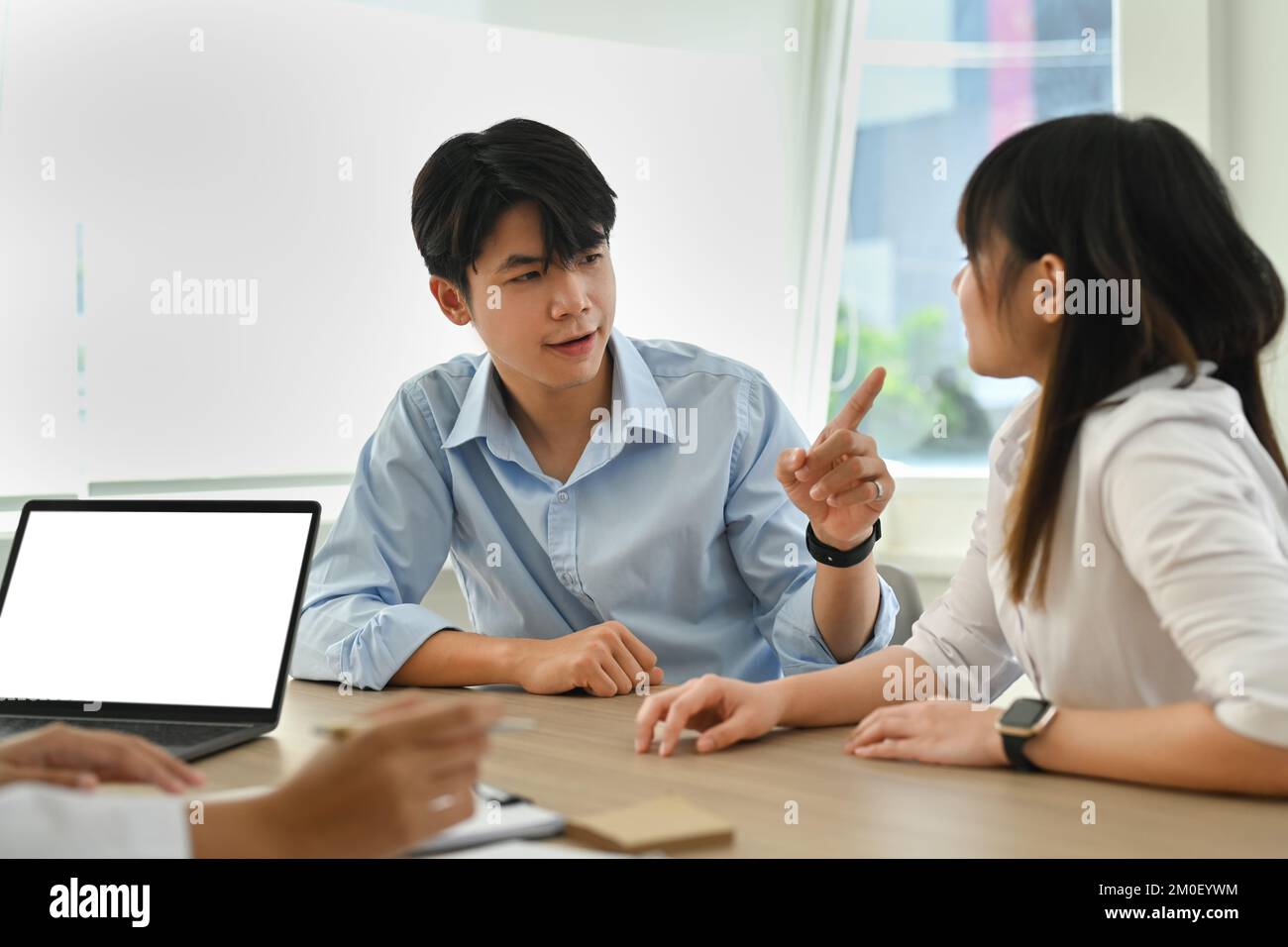 Asian couple arguing during family therapy counselling session with psychologist in clinic Stock Photo