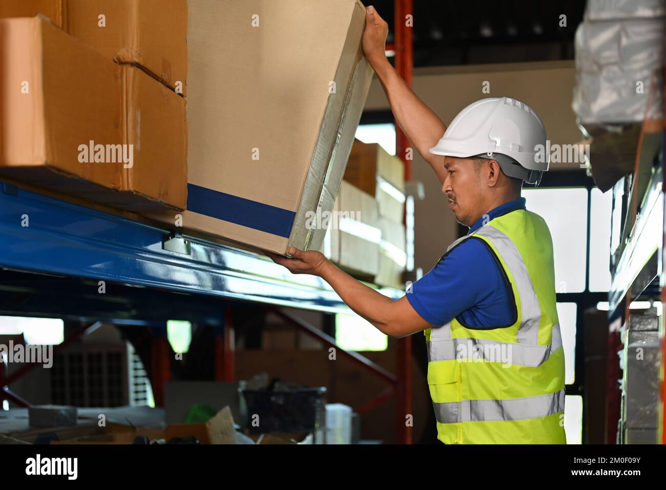 Man warehouse worker wearing hard hats and reflective jackets taking