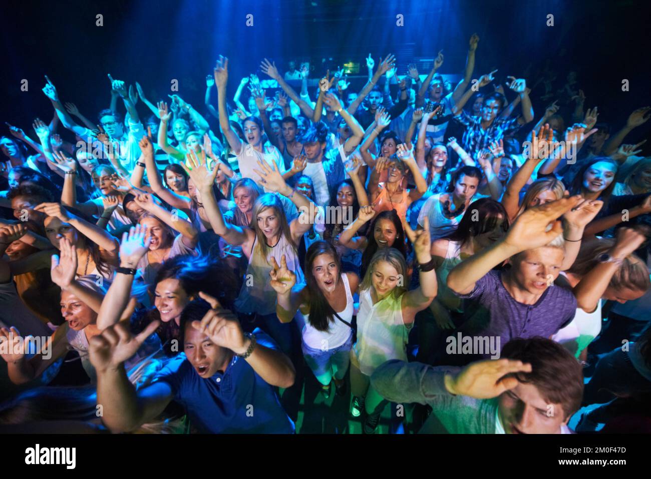 Dance, music and party with audience at concert for rock, festival or disco with live band performance. Celebration, social and nightclub show with Stock Photo