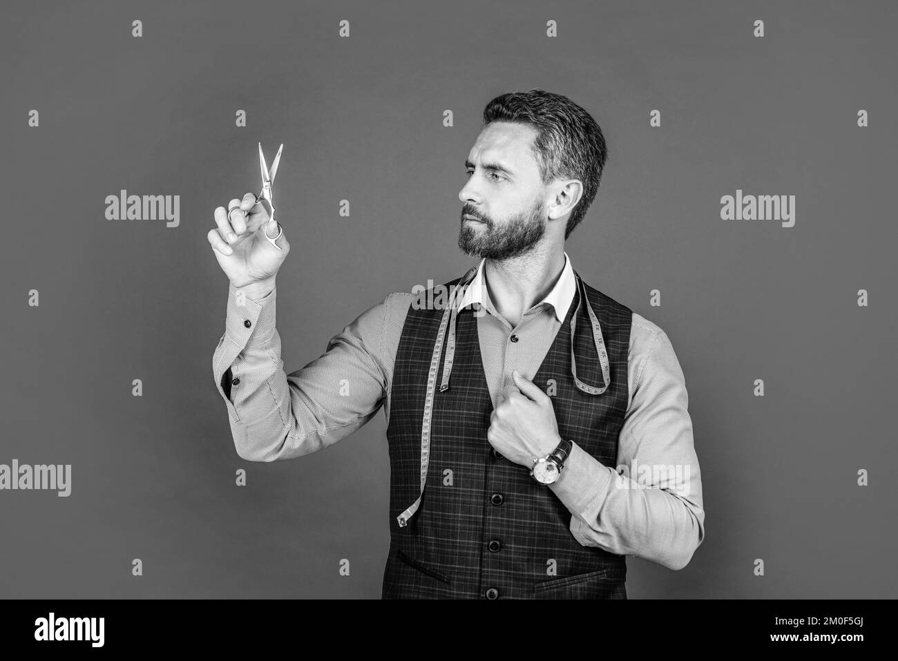 professional tailor with scissors and measuring tape. fashion designer