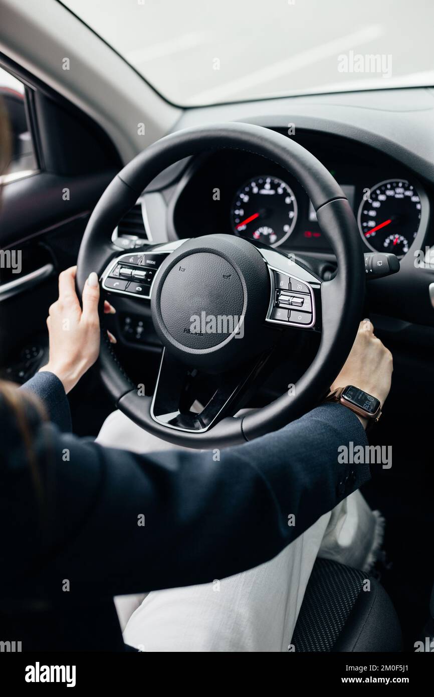 Close up of steering wheel in male driver hand, copy space. Man's hand