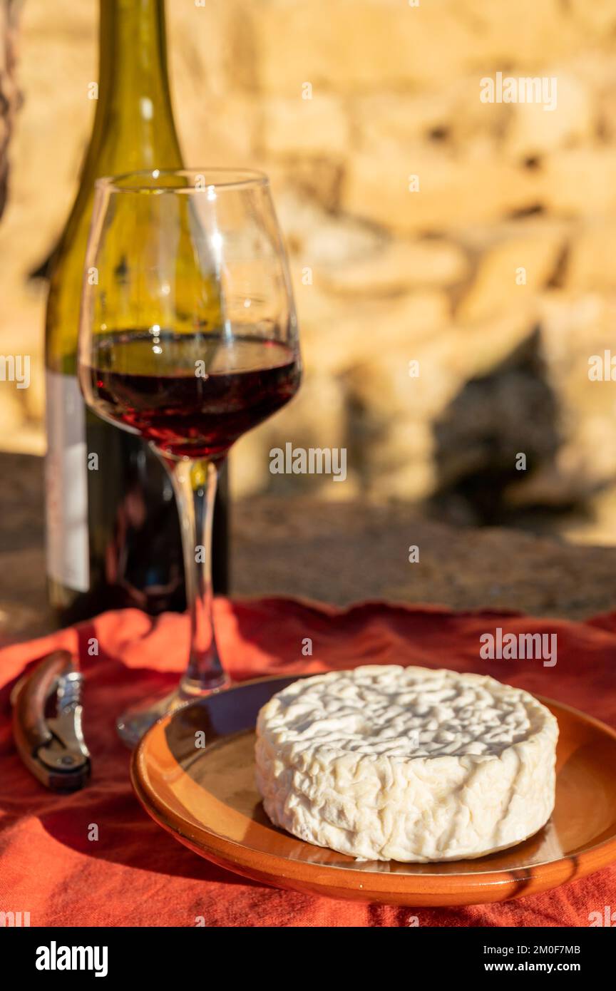 French wine and cheese pairing, glass of red beaujolais wine served