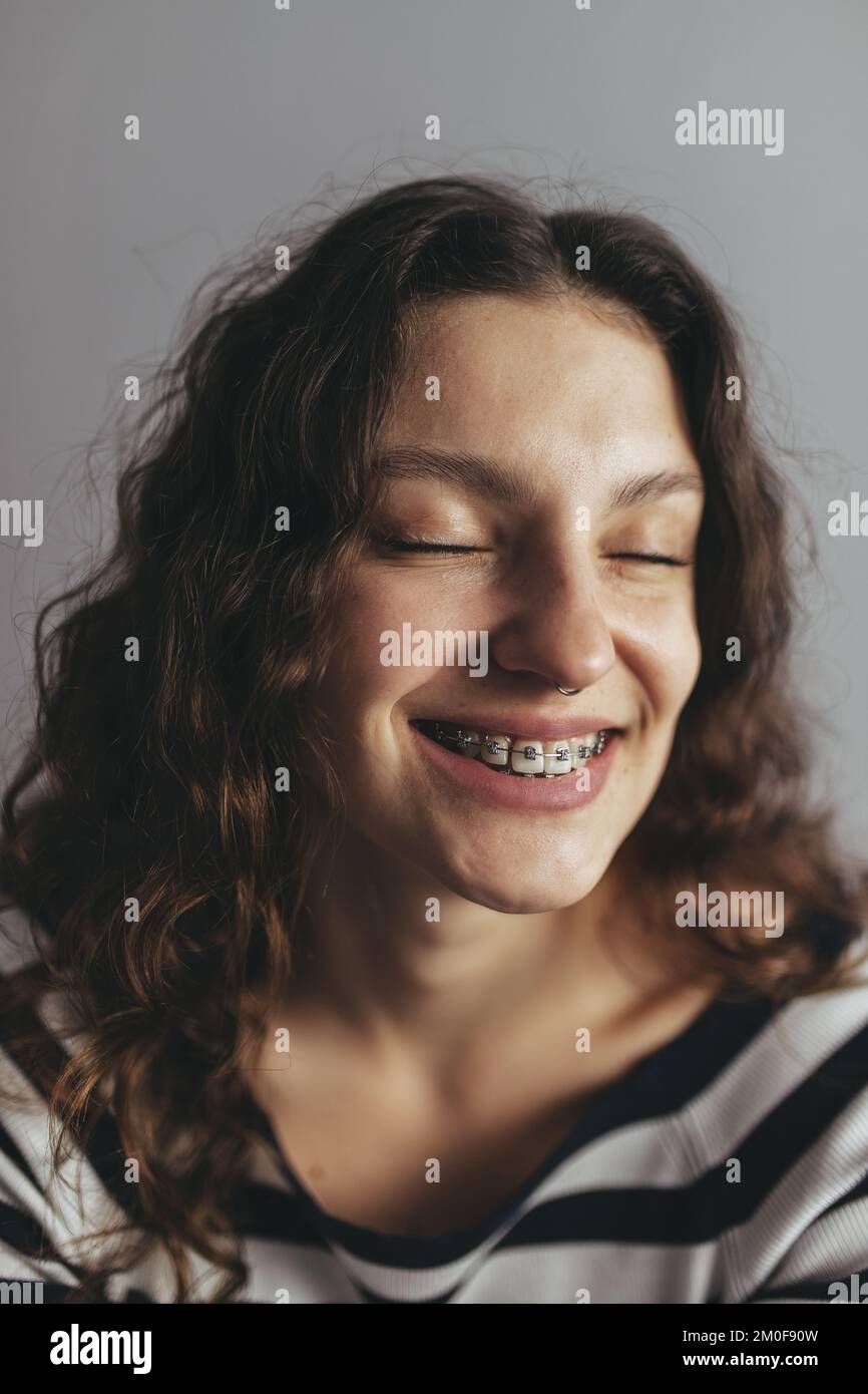 Woman with braces is smiling Stock Photo - Alamy