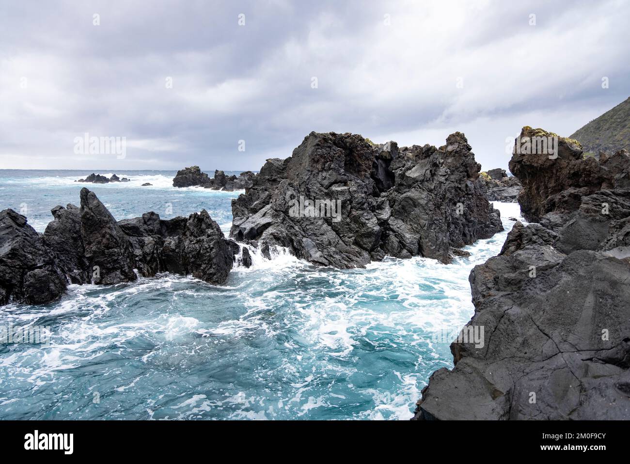 Rough sea with black volcanic rock in São Jorge, Azores Stock Photo