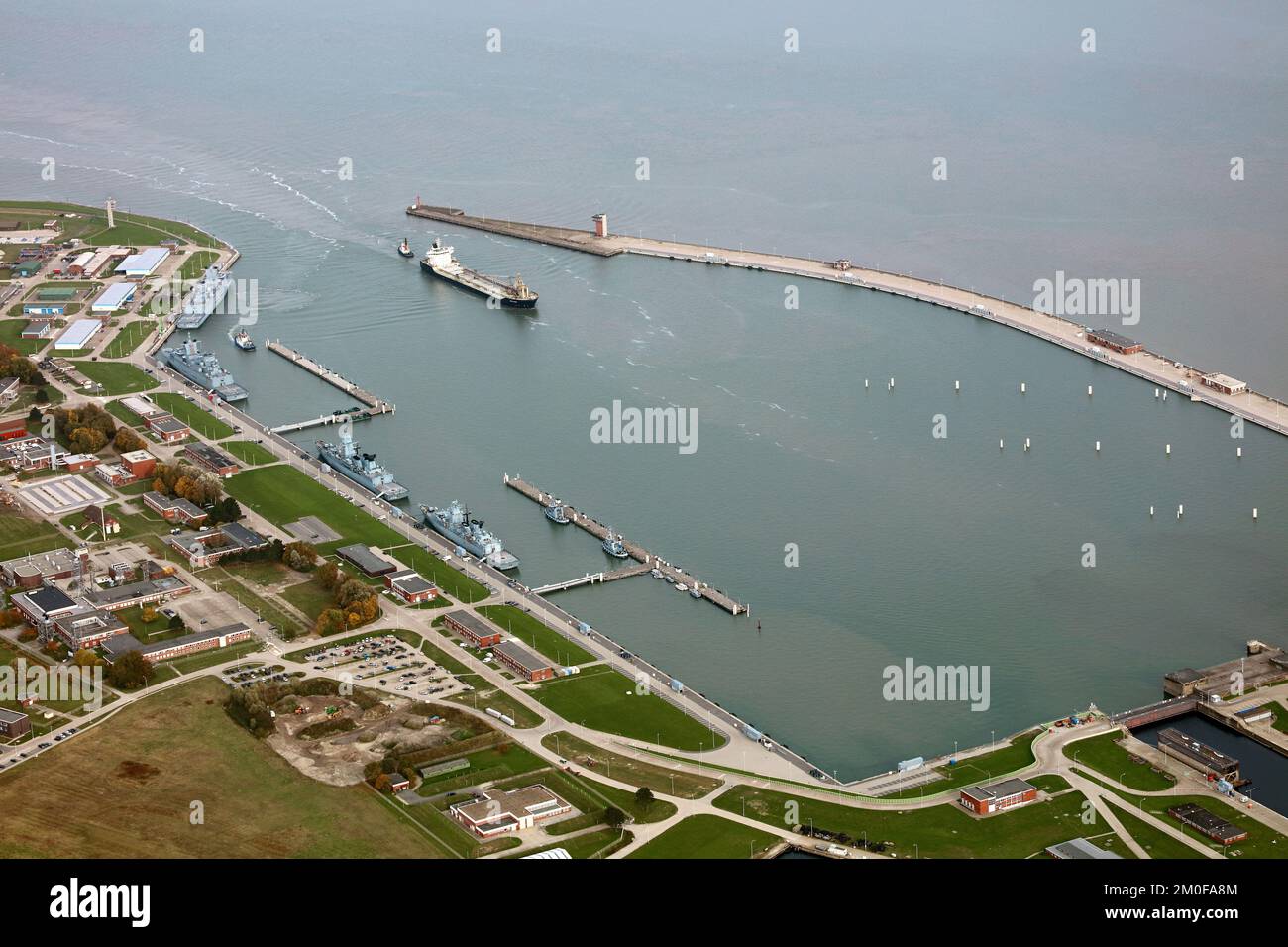 port of Wilhelmshaven with warships and incoming tanker, 28.10.2022, aerial photo, Germany, Lower Saxony, Wilhelmshaven Stock Photo