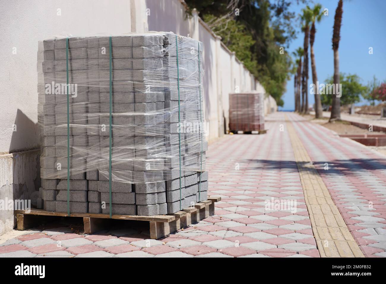 Paving stones on wooden pallet on the street sidewalk. Construction