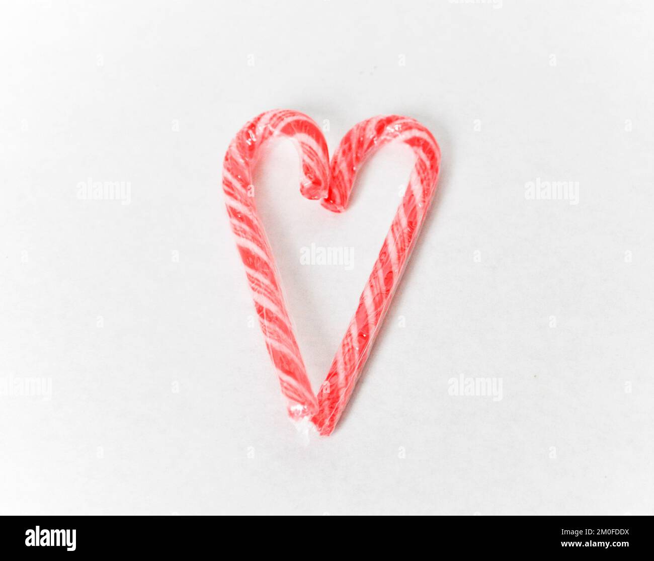 Traditional Christmas candy canes set to represent a love heart shape