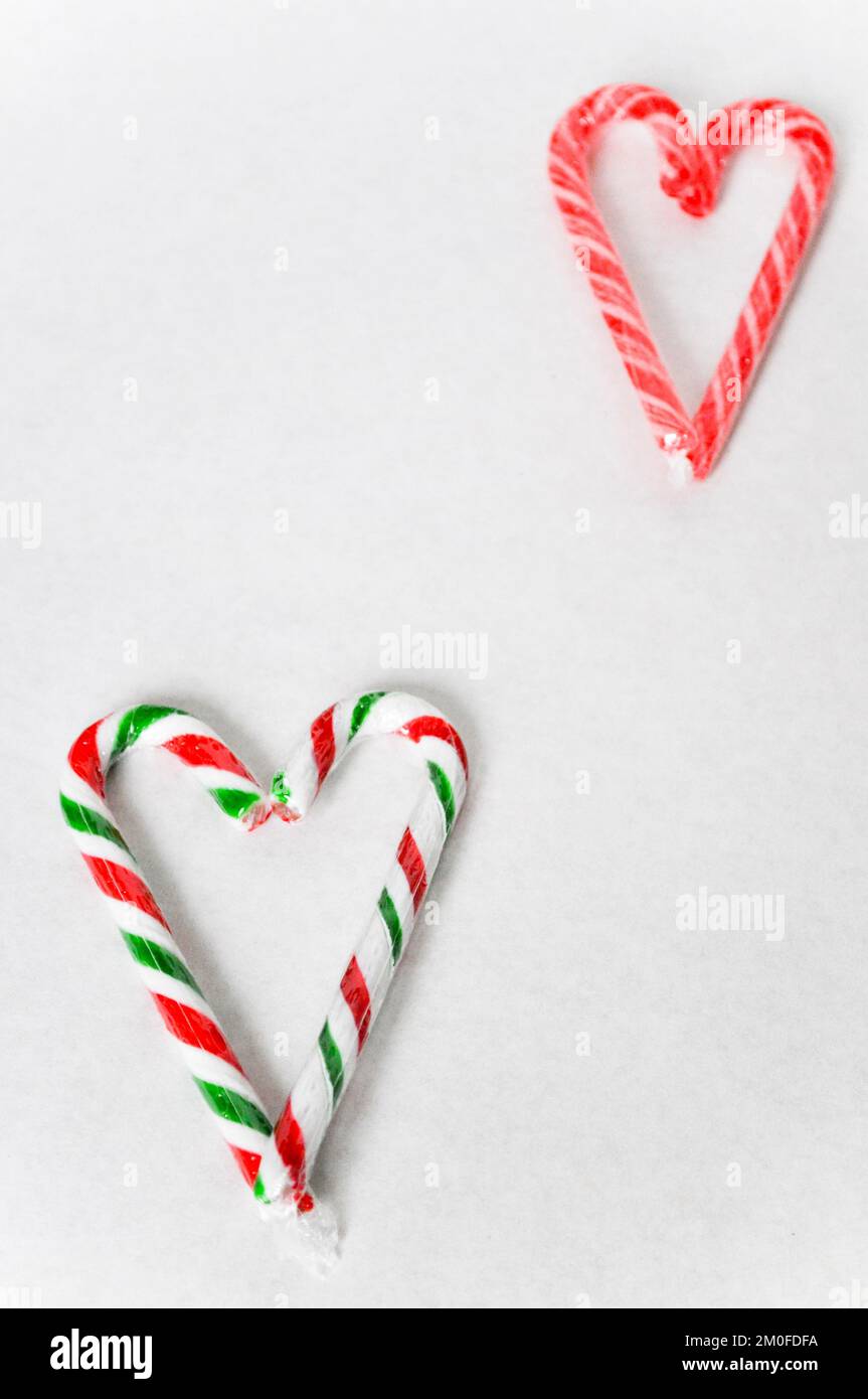 Traditional Christmas candy canes set to represent a love heart shape