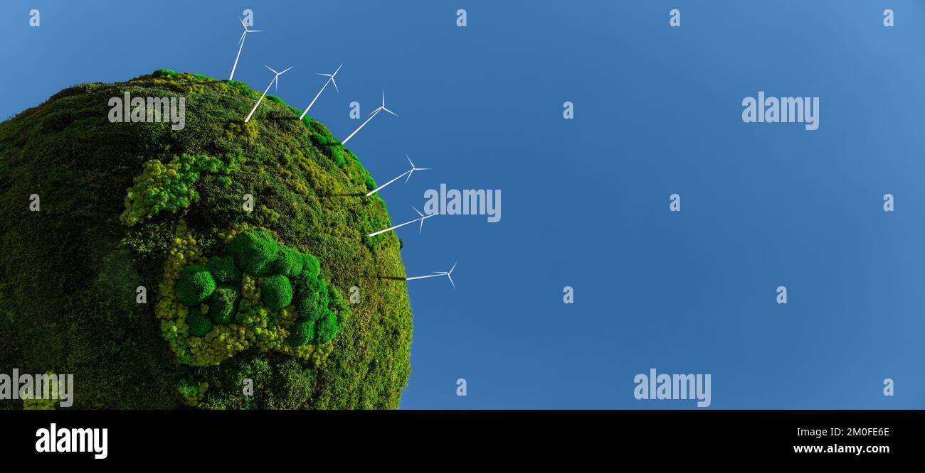 Model of the green planet Earth from moss with wind turbines. Symbol of sustainable development and renewable energy Stock Photo