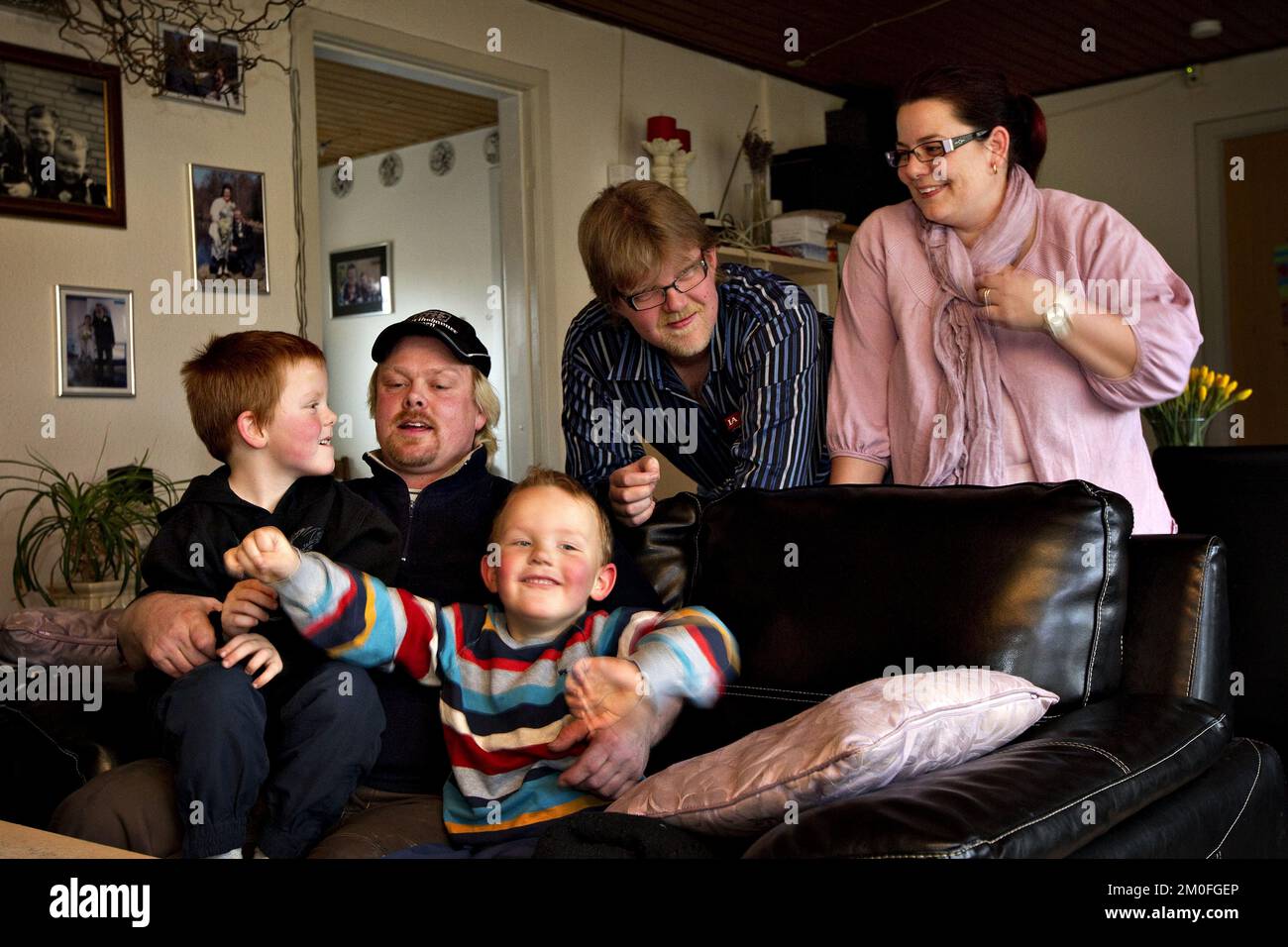 Michael Nielsen (second right) and his son Marcus (centre) alongside Tommy Kallehauge (second left) and son Lucas (left) with mother Charlotte Hilbrandt (right). Twins Marcus and Lucas, born 48 minutes apart have two different fathers. Mum Charlotte Hilbrandt became pregnant by ex-husband Michael and new boyfriend Tommy when she slept with both men within 48 hours. Stock Photo