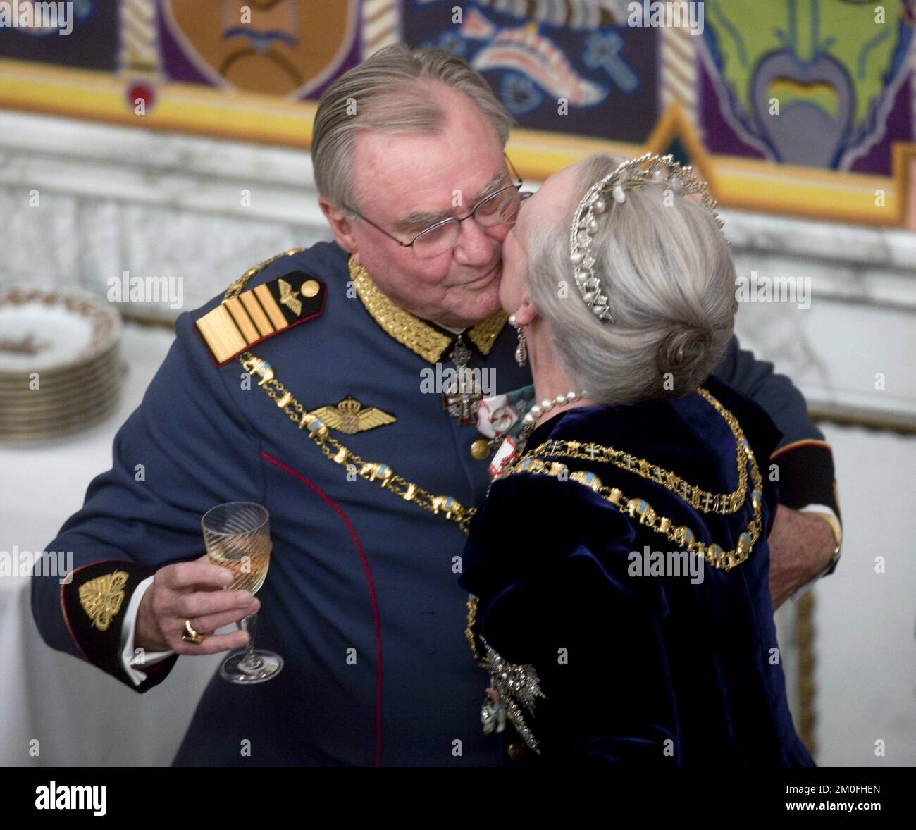 Denmark's Queen Margrethe II and Prince Consort Henrik kiss during the