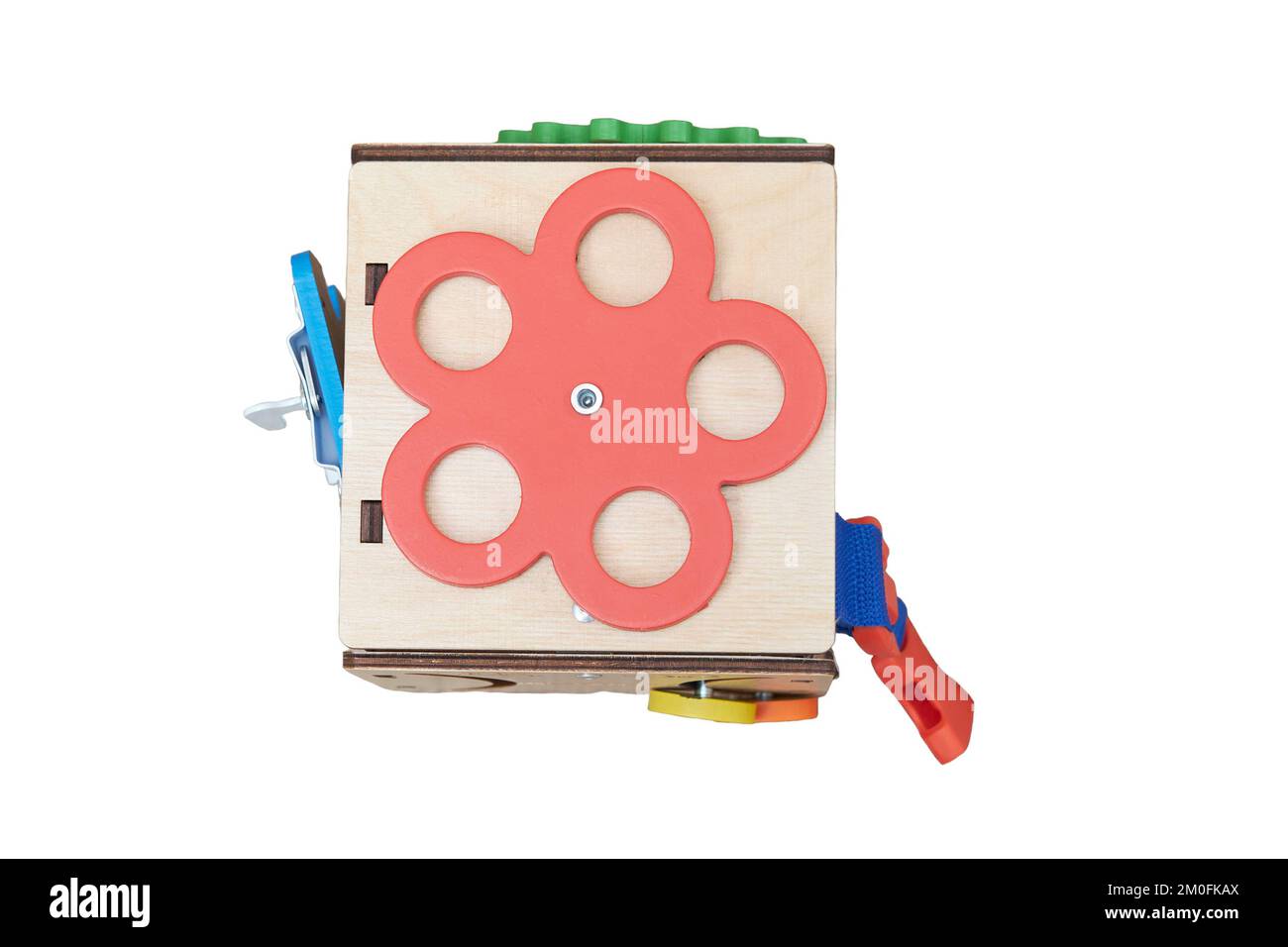 Busyboard cube for infant baby on the nursery floor, isolated on a white background. Educational toys for children, wooden gamepanel Stock Photo