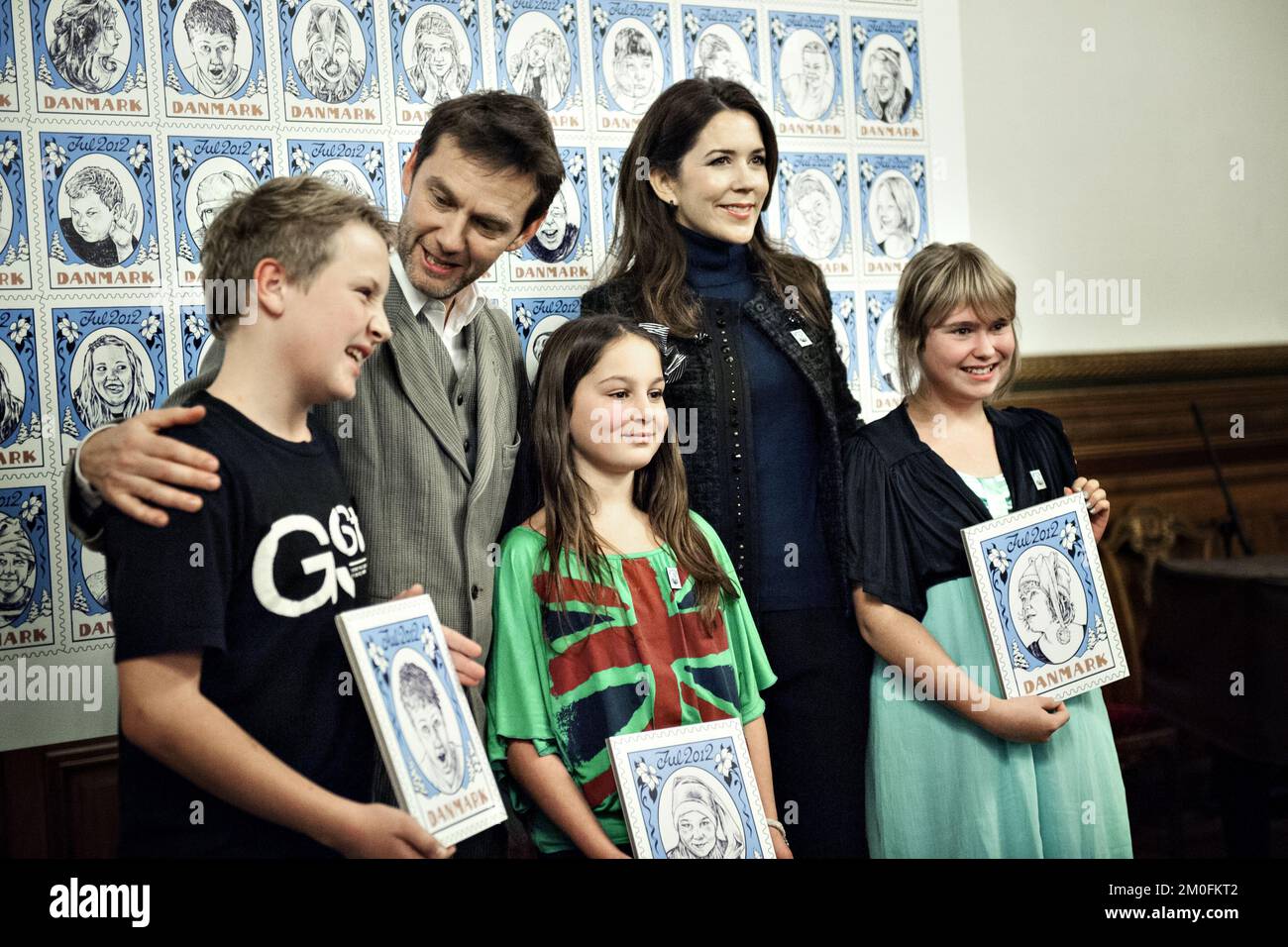 On Monday, October 29, 2012, Crown Princess Mary of Denmark was at theTown Hall in Copenhagen to attend the Christmas Seal Foundation launch of the 2012 Christmas Seal. The money from the sale of Christmas Seal will be donated to four Christmas Seal Homes, which serves as a temporary home for children who need help to break the vicious circle such as obesity or bullying.This yearÂ’s seal was designed by artist, Carl Quist MÃ¸ller, and the seal will be available for purchase on Tuesday, October 30, 2012. (Liv Hybye/POLFOTO) Stock Photo