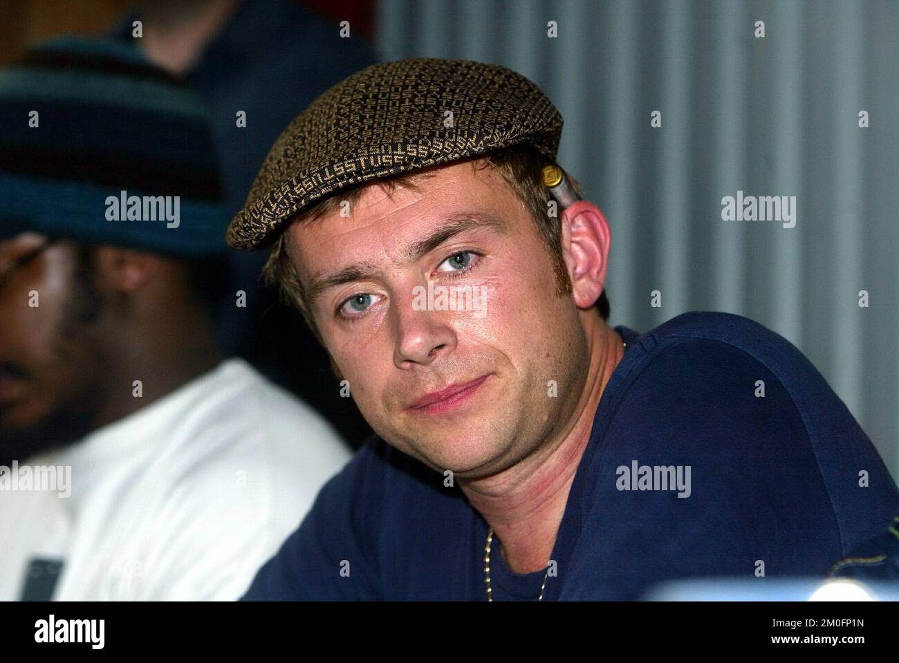 Lead singer of Blur, Damon Albarn with af  joint behind his ear during a pressmeeting at Roskilde Festival. Stock Photo