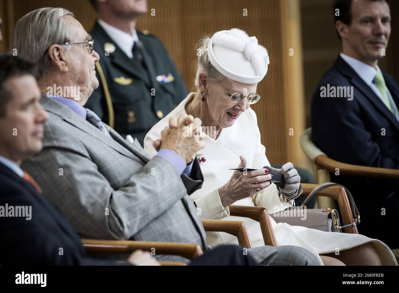 Queen Margrethe with the gift from Aarhus in hand, and Prince Henrik