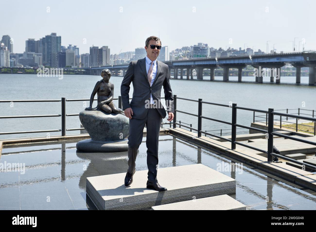 The Crown Prince Couple spent their last day in South Korea where they have been part of a business exposition tour promoting a stronger relationship between Denmark and South Korea. Here Crown Prince Frederik visited the river in Seoul where a replica of the Danish landmark The Little Mermaid has its place. The sculpture was a gift from the Danish State for their 2014 visit. He also visited the world's 5th highest building Lotte World Tower where he looked out over the city from the 555 meter high observation deck. Stock Photo