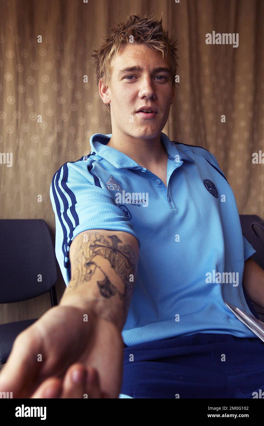 Nicklas Bendtner proudly shows off his new tattoo during Friday's press
