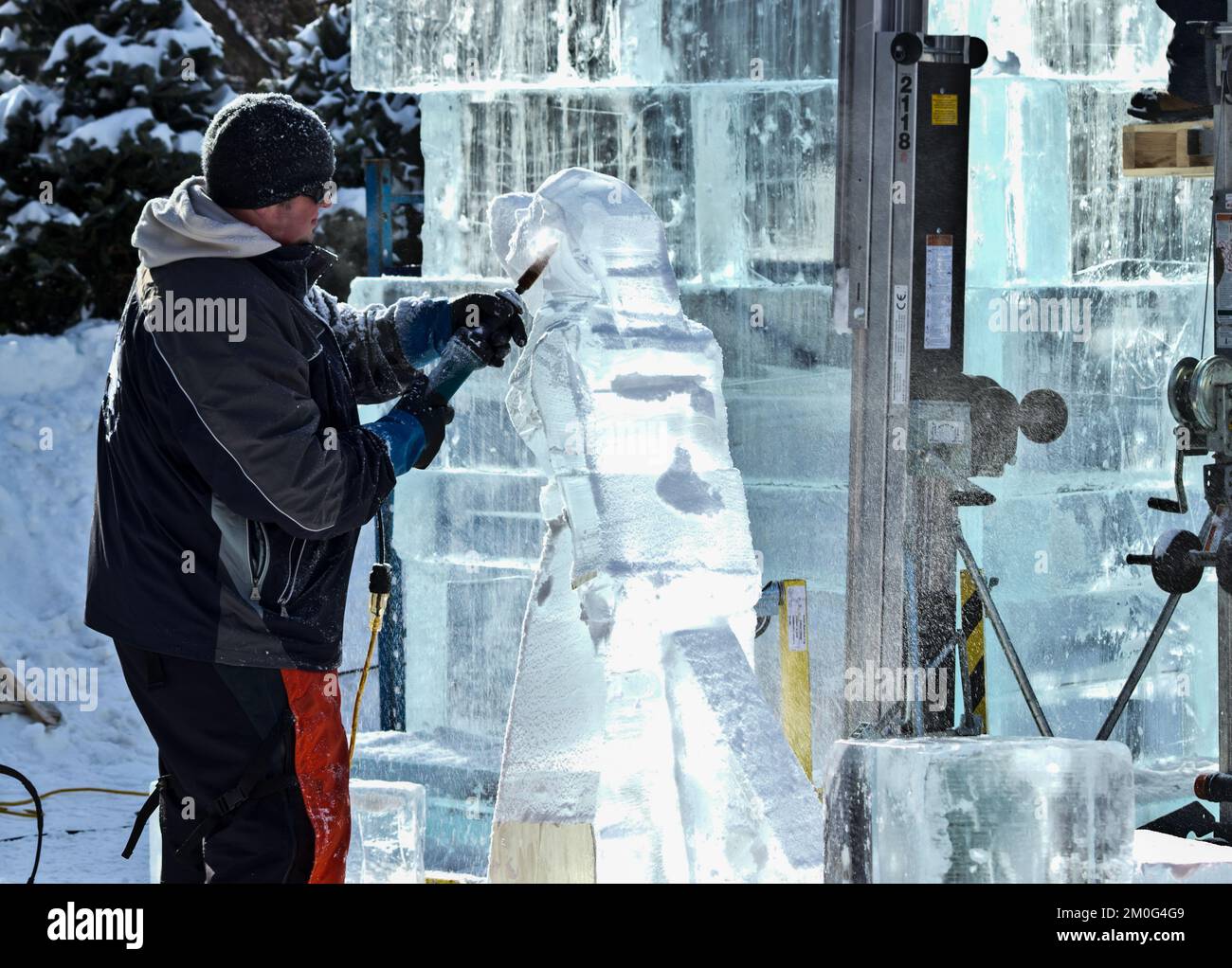 A man carves ice sculptures during a winter festival Stock Photo