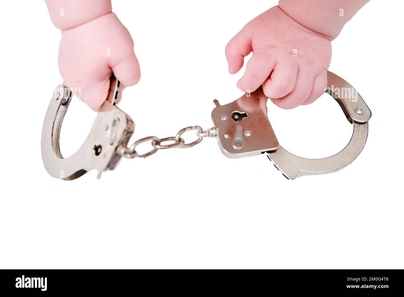 Baby hand and handcuffs, closeup, isolated on a white background
