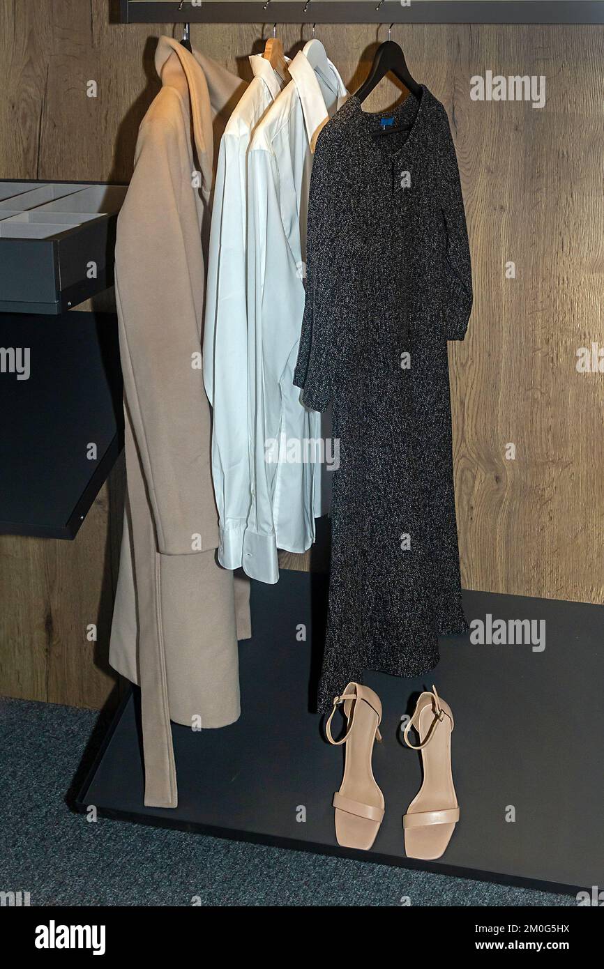 Clothes on the hangers inside walk in closet Stock Photo
