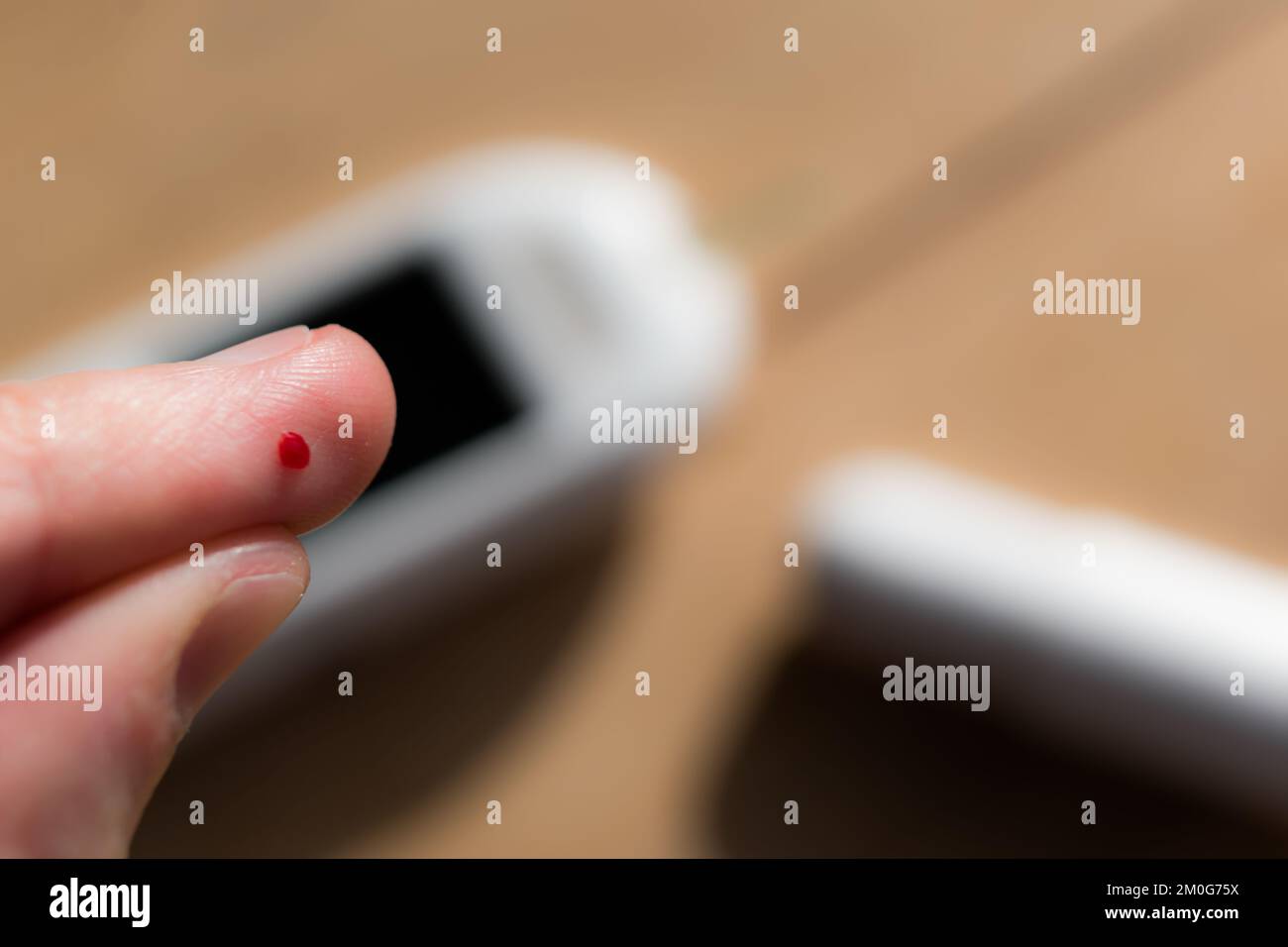 Woman pricking her finger to check blood glucose level with