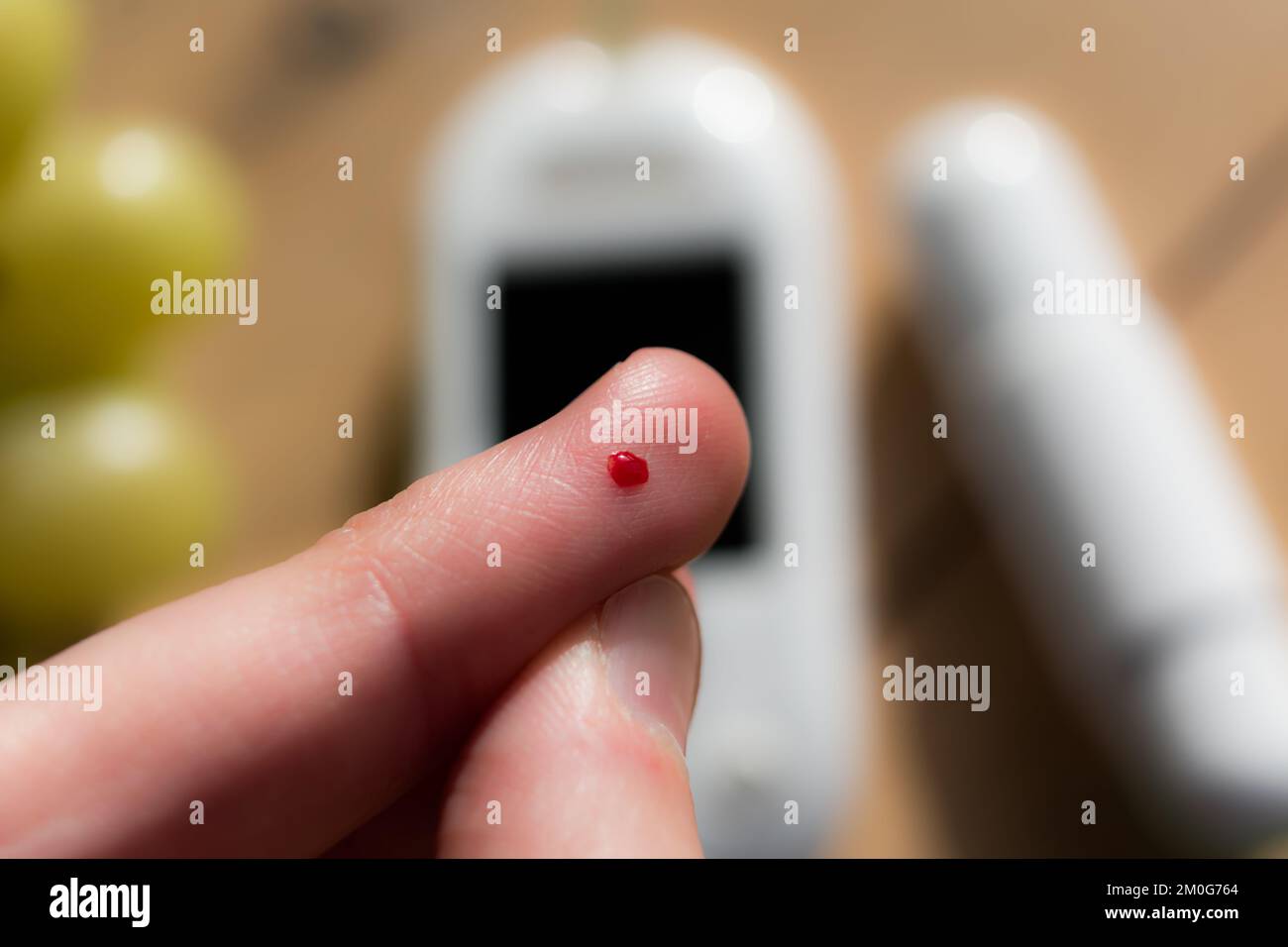 Woman pricking her finger to check blood glucose level with