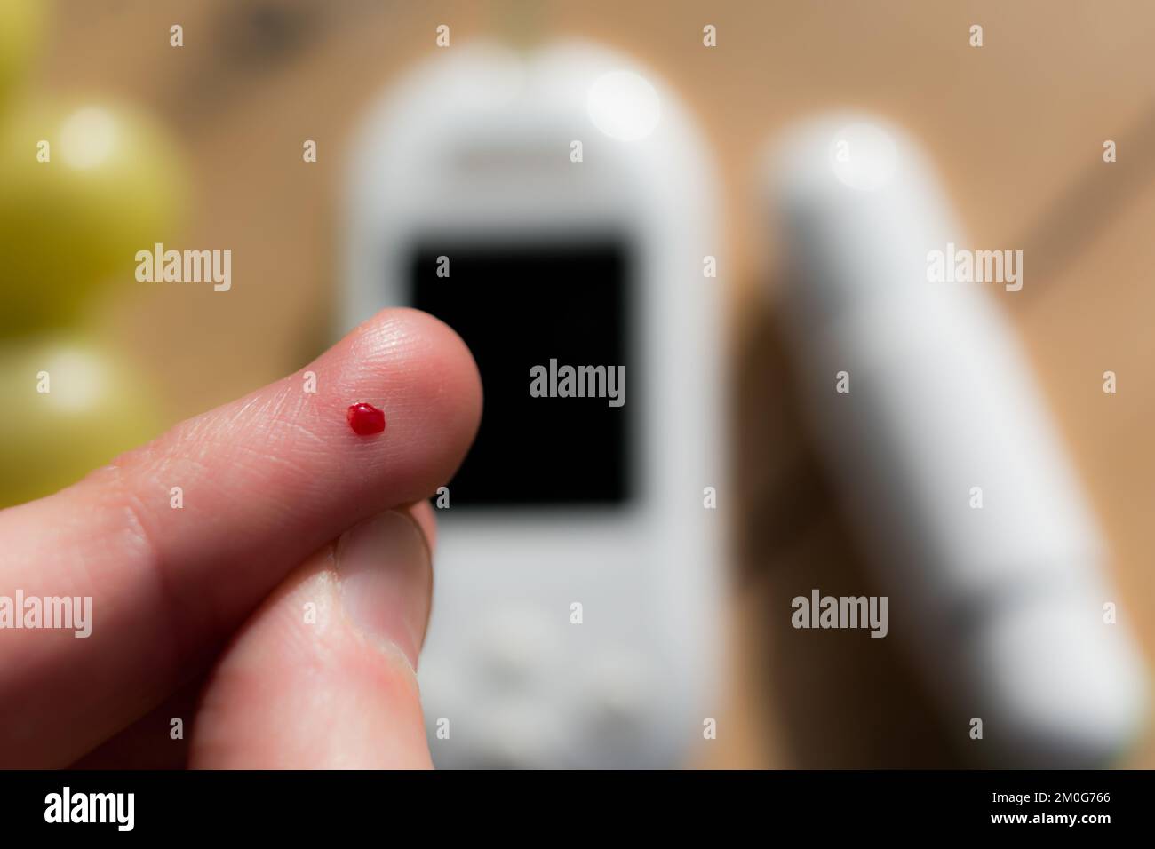 Woman pricking her finger to check blood glucose level with