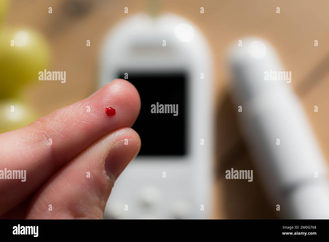 Woman pricking her finger to check blood glucose level with