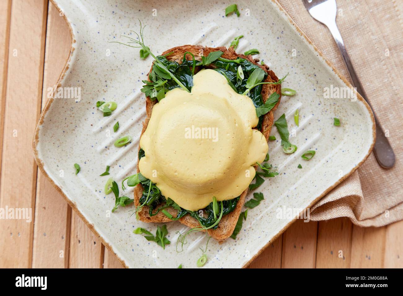Vegan alternative eggs benedict plantbased sauce, sourdough bread