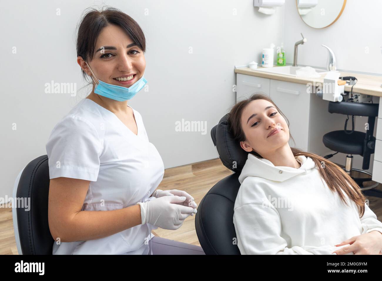 Orthodontist checking brackets on female teeth. Concept of stomatology