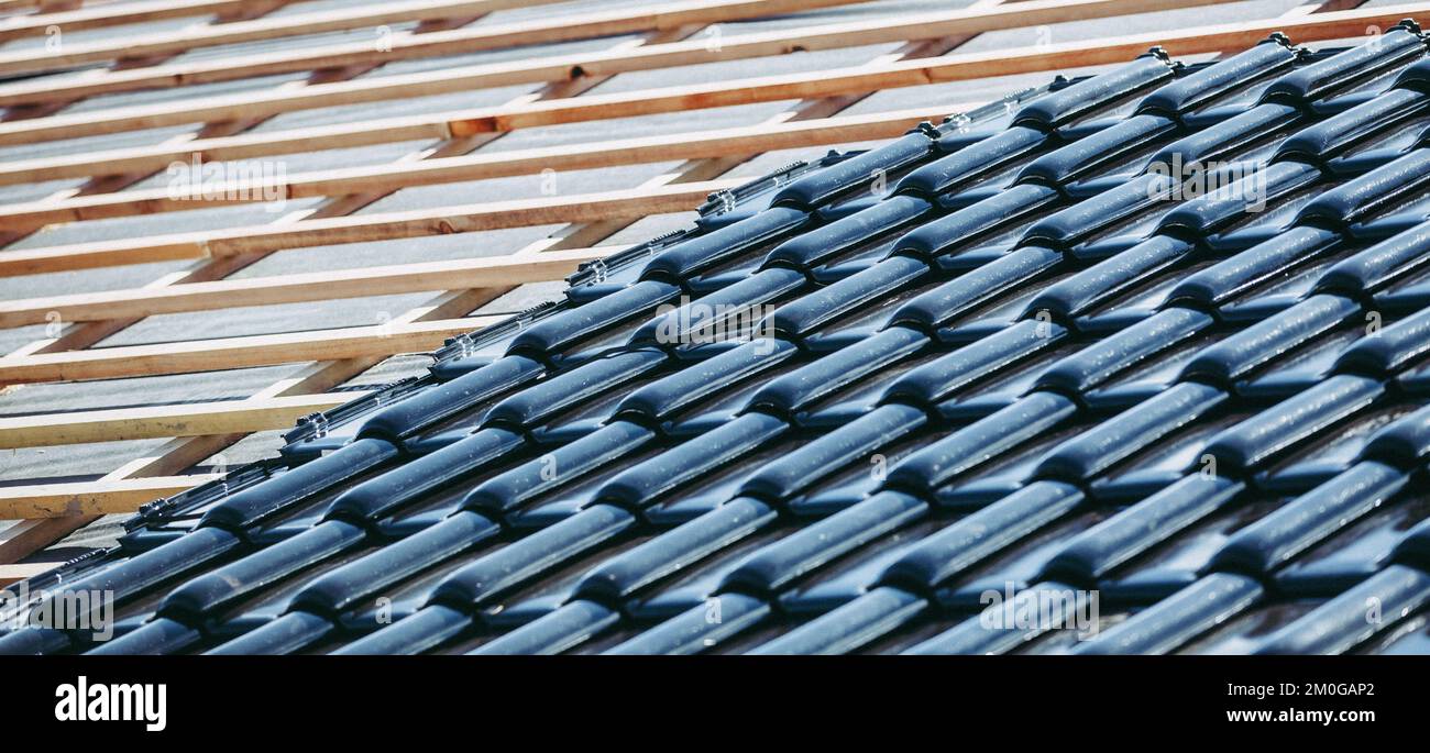 Black roof of burnt tiles reconstruction for the old house, building