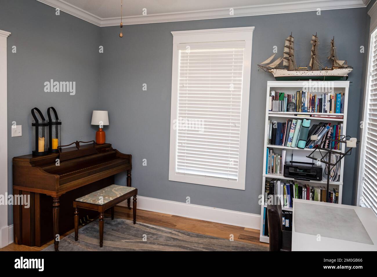 Home music room for students with a wood piano and blue gray walls Stock Photo