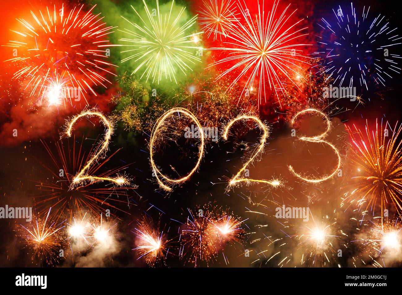 2023 Happy New Year written with Sparkle firework on black night sky. Fireworks background. Stock Photo