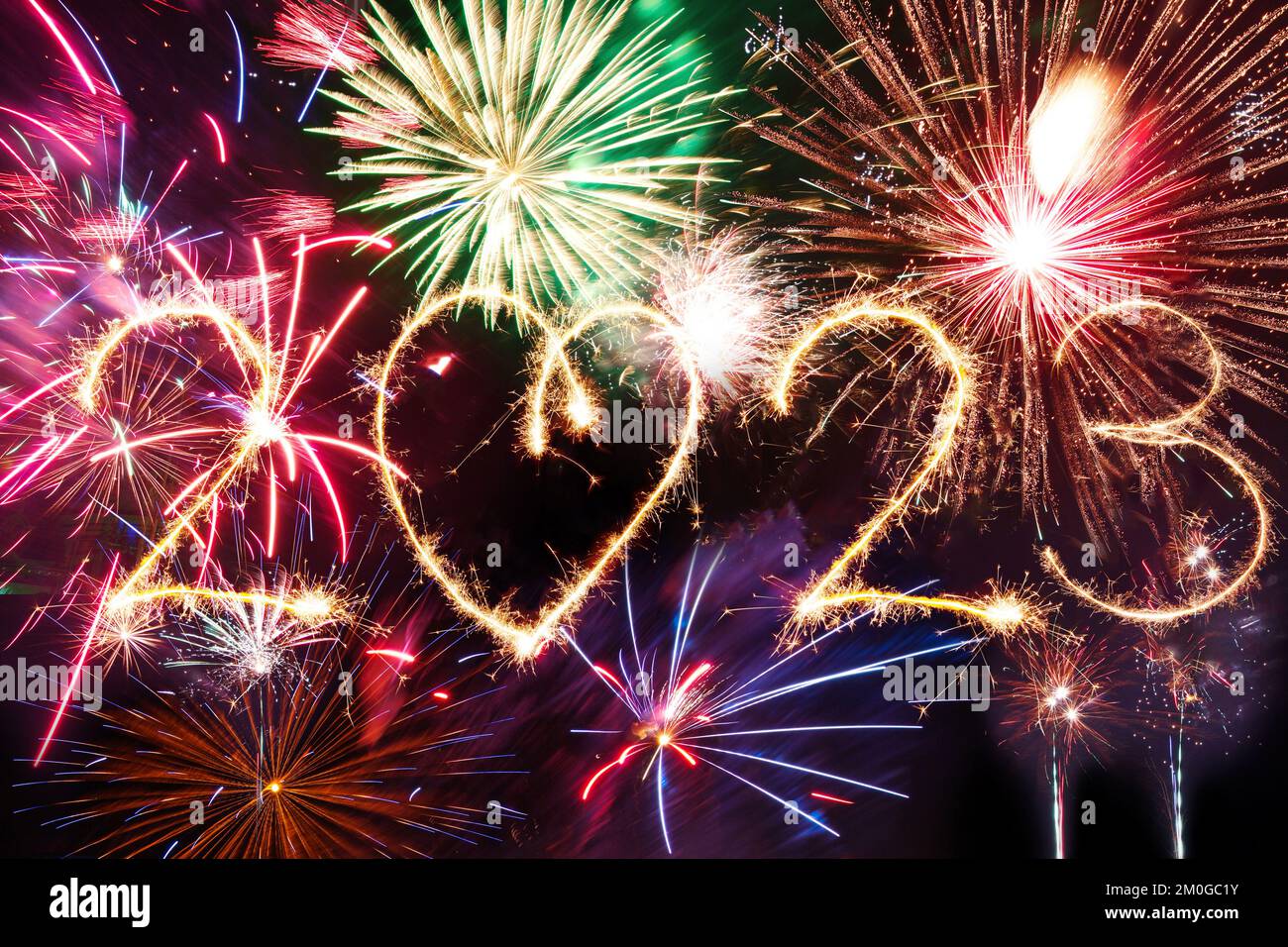 2023 Happy New Year written with Sparkle firework on black night sky. Fireworks background. Stock Photo