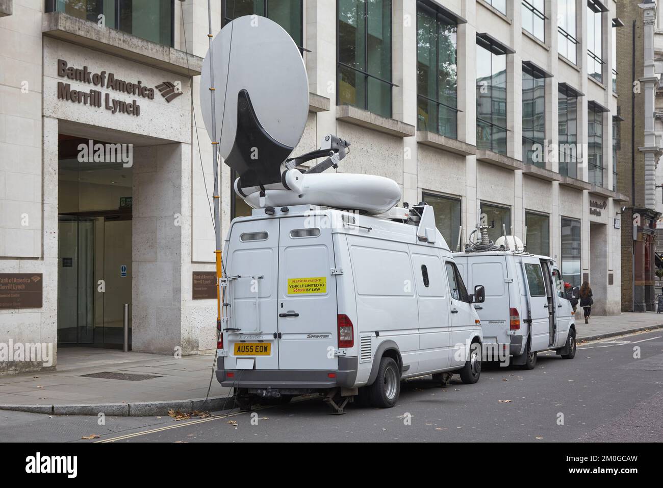 TV broadcast van with satellite dish outside the Bank of America Merrill Lynch branch in London, UK Stock Photo