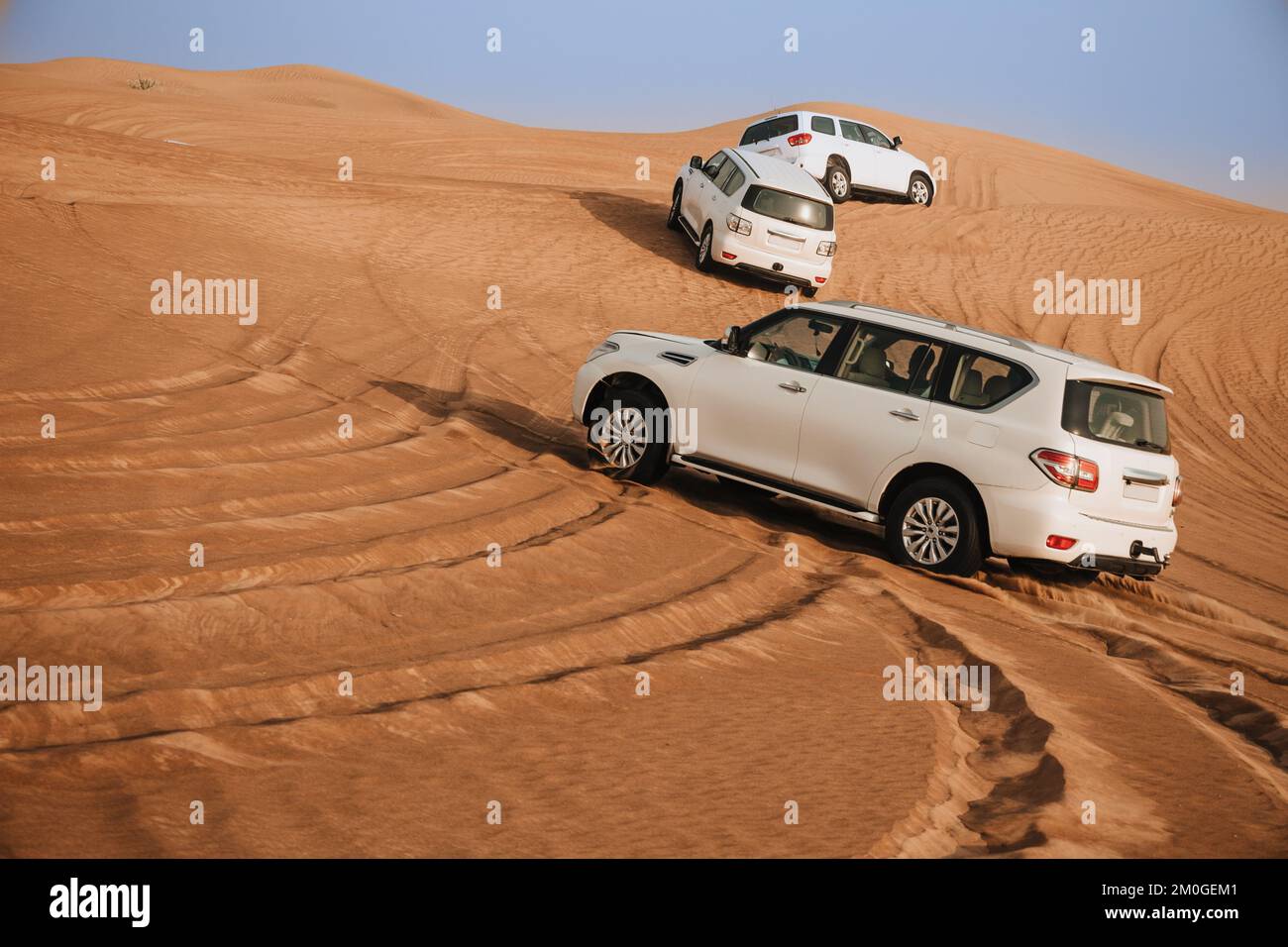 Dubai, United Arab Emirates - 01, July 2021 : Race in sand desert. Competition racing challenge desert. Car drives offroad with clouds of dust. Offroad vehicle racing with obstacles in wilderness Stock Photo