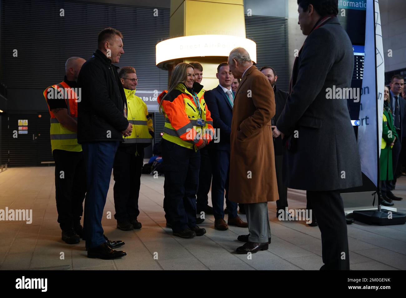 King Charles III meets airport staff during a visit to Luton Airport to