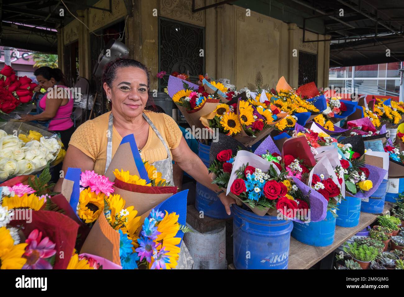 Woman selling flowers in a square in the urban center of San José in Costa Rica Stock Photo