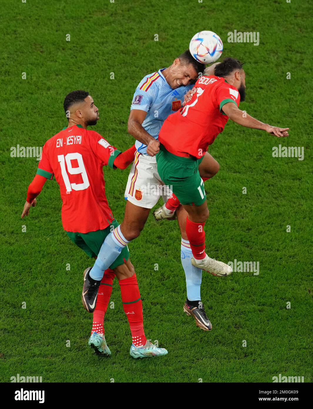 Spain's Rodri (centre) battles with Morocco's Sofiane Boufal (right) and Youssef En-Nesyri during the FIFA World Cup Round of Sixteen match at the Education City Stadium in Al-Rayyan, Qatar. Picture date: Tuesday December 6, 2022. Stock Photo