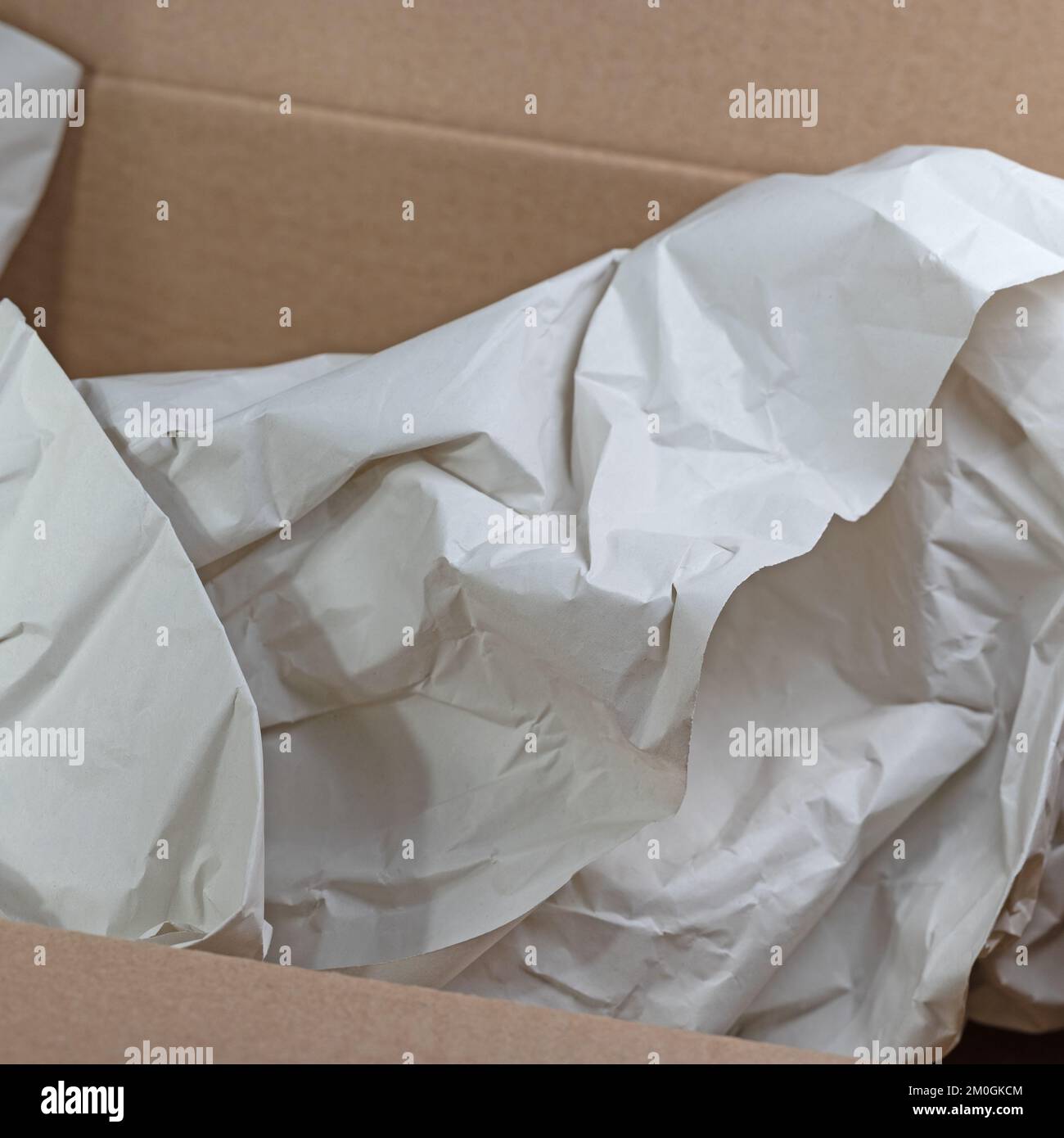 Empty cardboard box with crumpled wrapping paper Stock Photo Alamy